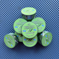 A stack of green washi tape rolls labeled 'Maggie's Kickass Washi Tape' and 'Pickleball!!' on a blue textured background.